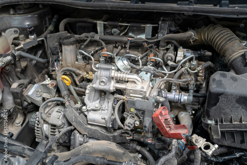 Checking and repairing an internal combustion engine in an auto repair shop.