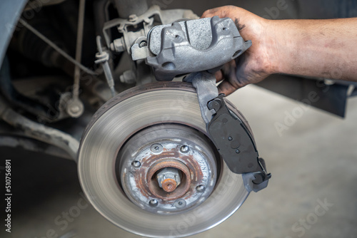 Vehicle's disc brake inspection and maintenance for repair. Car brake repair in garage. close-up photo