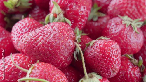 Ripe red strawberries with green leaves, 4K