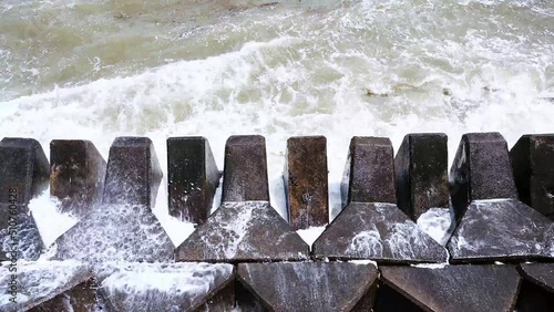 Waves hitting the breakwater concrete tetrapods
