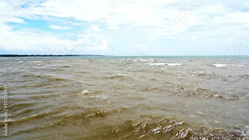 Muddy wave on the outlet of river.