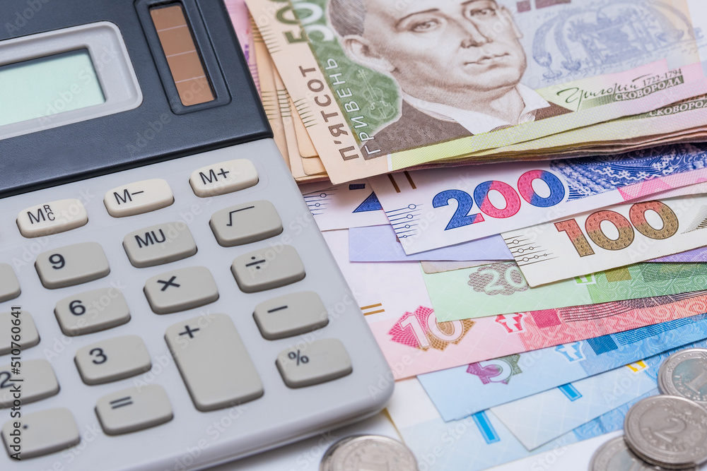 Ukrainian hryvnia and coins, background. Concept of receiving a salary, pension, inflation, deposit and credit. Concept of increasing the price of utilities, energy, gast Ukrainian hryvnia and coins, background. Concept of receiving a salary, pension, inflation, deposit and credit. Concept of increasing the price of utilities, energy, gast