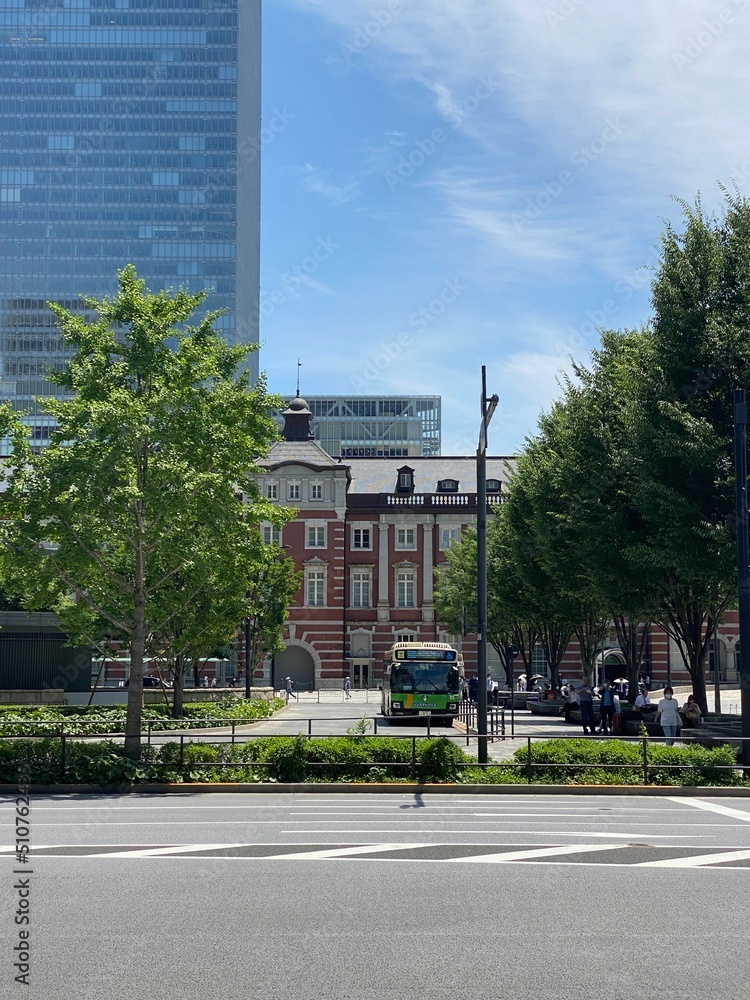 Fototapeta premium The Tokyo station square, with bus stops and modern office buildings, shot taken on year 2022 June 13th, sunny weekday