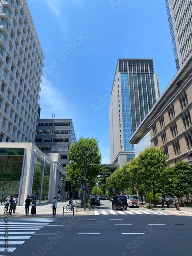 Street pedestrian’s crossings at the Tokyo Station square, city high buildings and the environment, year 2022 June 13th, sunny weekday Japan