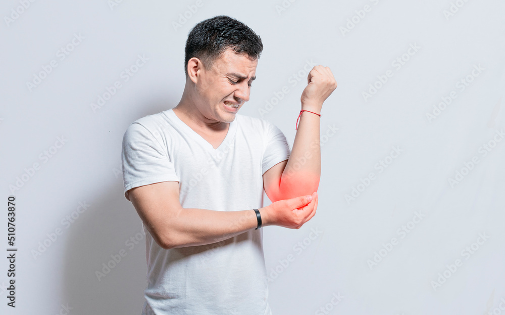 Person with elbow pain, concept of a man with rheumatism elbow pain, man massaging sore elbow, man with elbow cramp Person with elbow pain, concept of a man with rheumatism elbow pain, man massaging sore elbow, man with elbow cramp