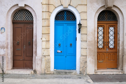 Traditional vintage painted wooden door in Malta. Popular travel destination. Entrance to house. Exterior of typical houses on the Mediterranean island of Malta - April, 2022. © Yuliya