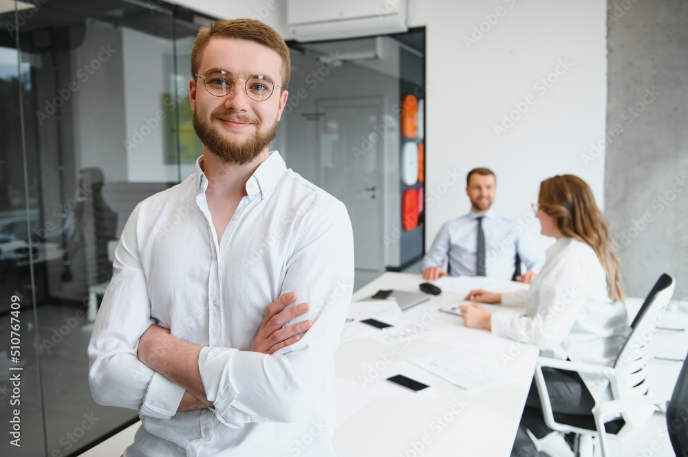 Portrait of a leader with business team behind. Portrait of a leader with business team behind.