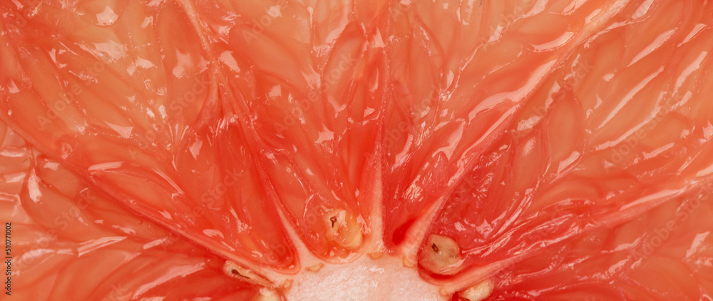 Grapefruit slice macro texture. Grapefruit citrus fruit background. Grapefruit slice macro texture. Grapefruit citrus fruit background.