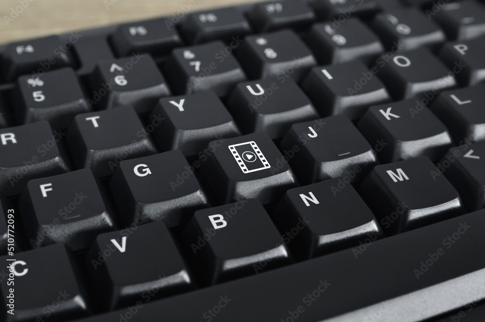 Play button with movie flat icon on black computer keyboard button, Business cinema online concept Play button with movie flat icon on black computer keyboard button, Business cinema online concept