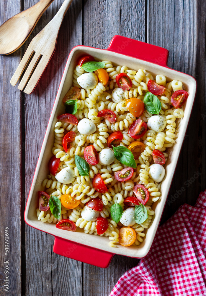 Fusilli pasta with mozzarella, tomatoes and basil. Italian food. Healthy eating. Vegetarian food. Fusilli pasta with mozzarella, tomatoes and basil. Italian food. Healthy eating. Vegetarian food.