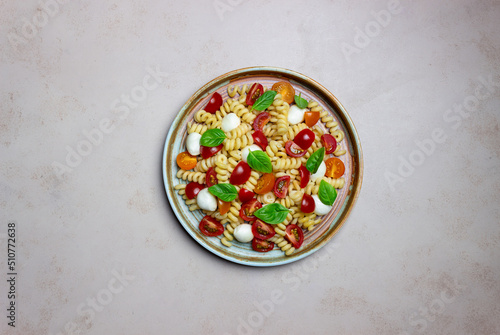 Fusilli pasta with mozzarella, tomatoes and basil. Italian food. Healthy eating. Vegetarian food.