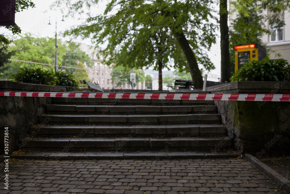 Red and white protective tape fencing off dangerous areas Red and white protective tape fencing off dangerous areas