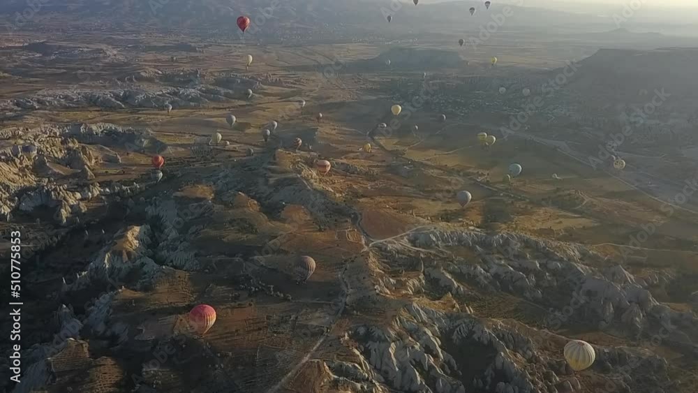 Aerial tilt to Turkish sky full of hot air balloons just after sunrise Aerial tilt to Turkish sky full of hot air balloons just after sunrise