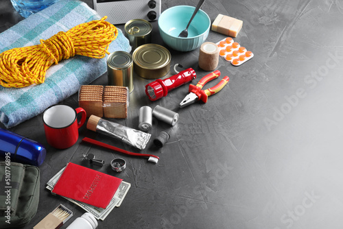 Earthquake supply kit on dark grey table. Space for text