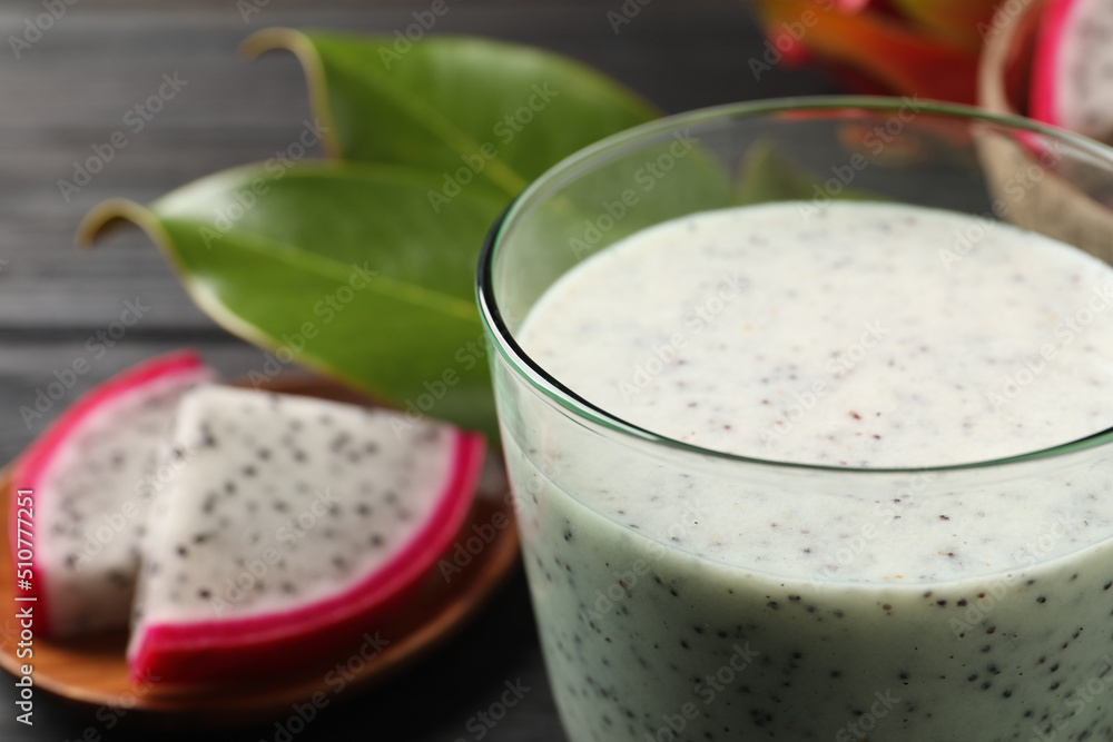 Delicious pitahaya smoothie and fresh fruits on table, closeup. Space for text Delicious pitahaya smoothie and fresh fruits on table, closeup. Space for text