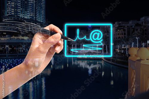 Electronic signature concept. Double exposure of woman with pen near virtual screen and night cityscape photo