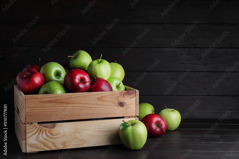 Fresh ripe red and green apples on black wooden table, space for text Fresh ripe red and green apples on black wooden table, space for text