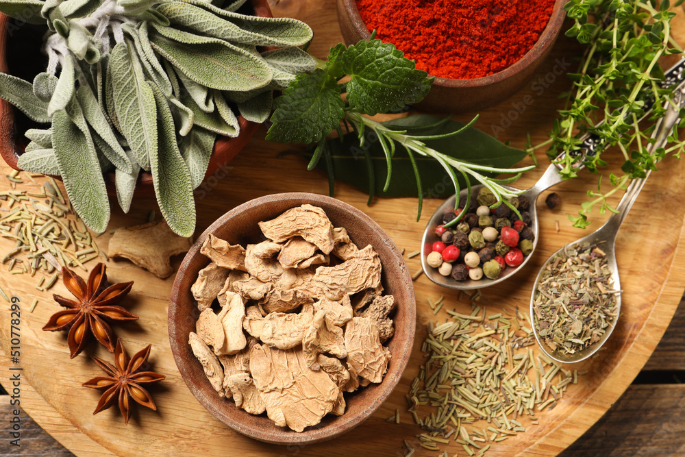 Different herbs and spices on wooden table, top view Different herbs and spices on wooden table, top view