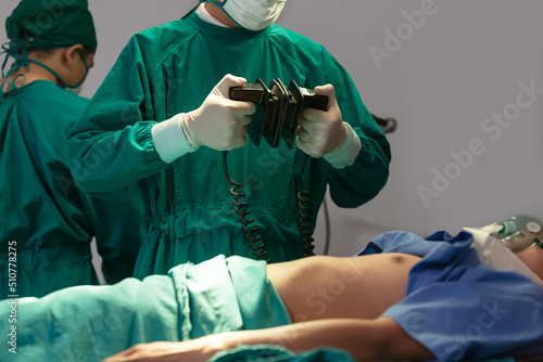 фотографія Medical staff work in the intensive care ward with defibrillator in operation
