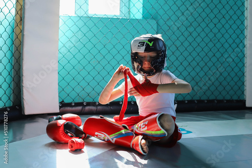 The boy is preparing for a boxing fight, Thai boxing.