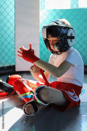 The boy is preparing for a boxing fight, Thai boxing.