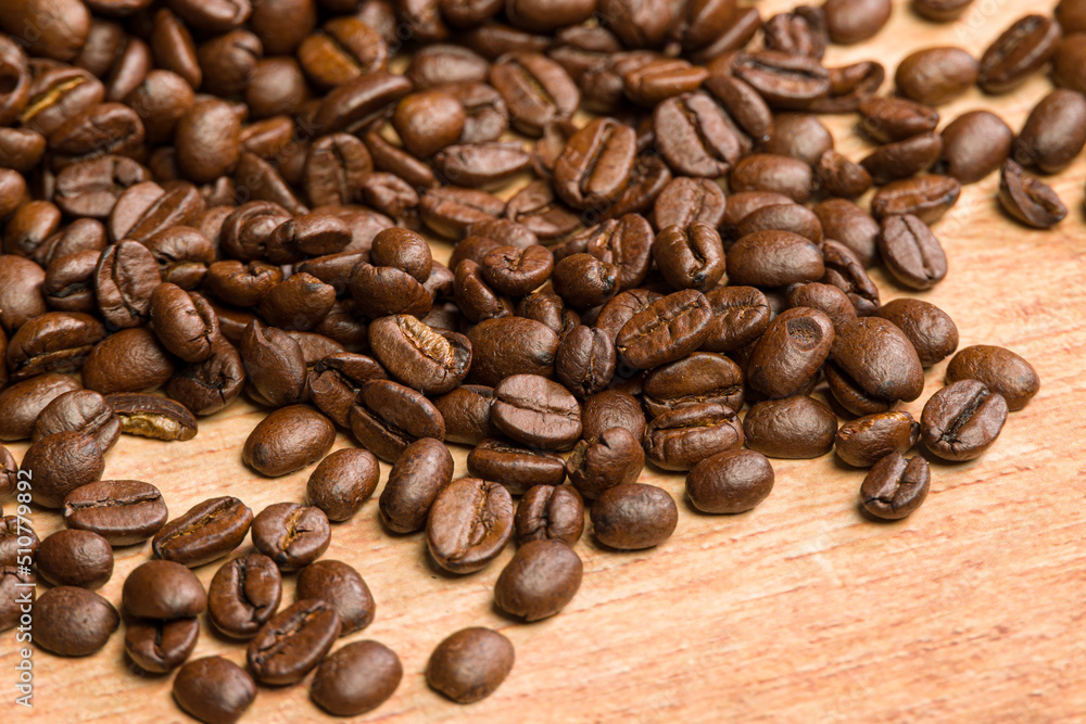 close-up of coffee beans on a wooden table close-up of coffee beans on a wooden table