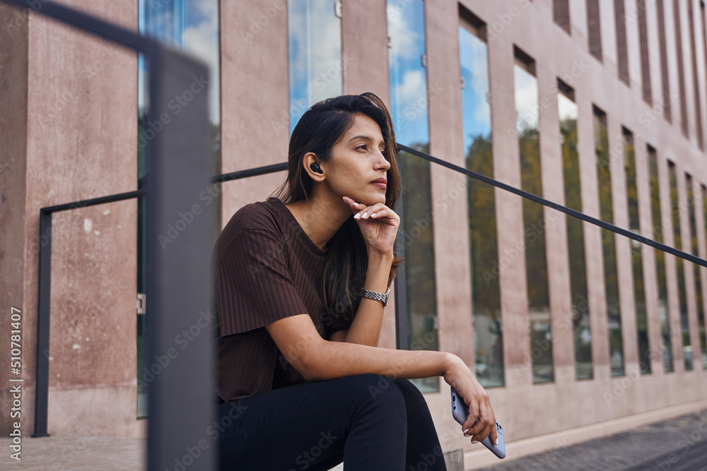 Young businesswoman looking away and thinking Young businesswoman looking away and thinking