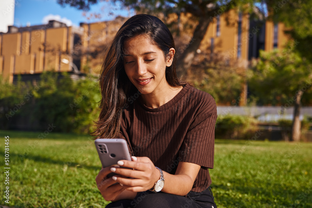 Young businesswoman in park text messaging Young businesswoman in park text messaging