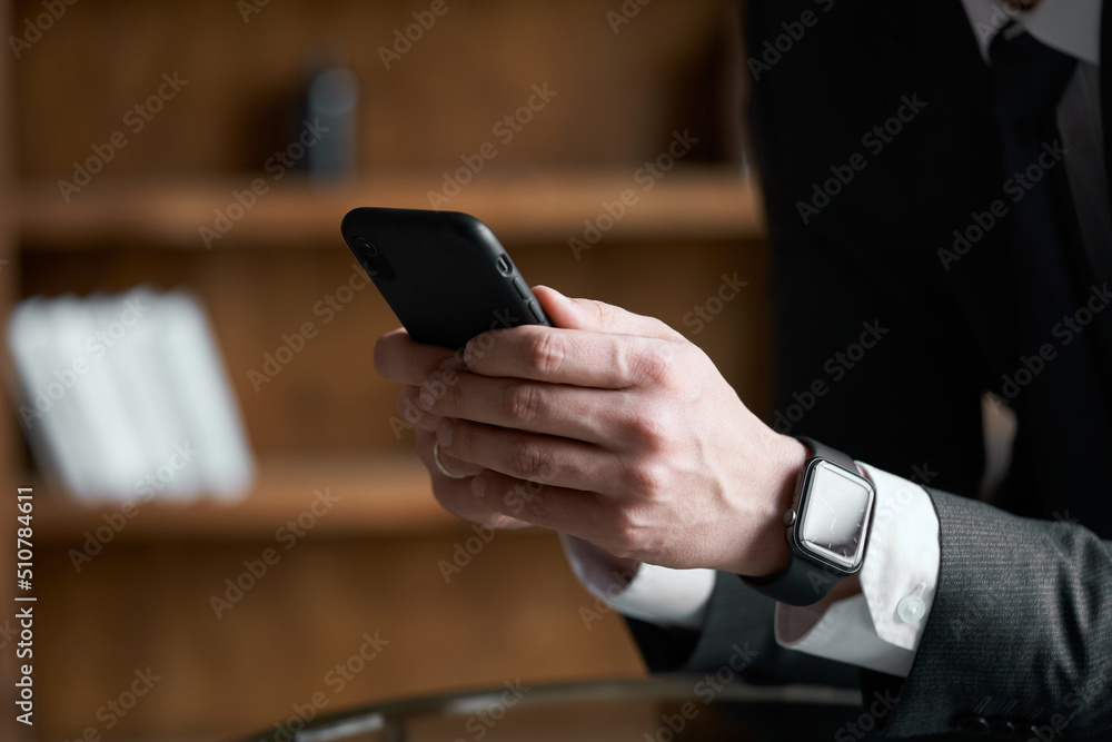 Businessman using his mobile phone. Male hands using smartphone. Cell phone Mockup image blank. Man hand holding, texting, using mobile. Background empty space for advertise. Businessman using his mobile phone. Male hands using smartphone. Cell phone Mockup image blank. Man hand holding, texting, using mobile. Background empty space for advertise.