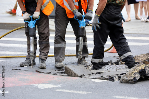 Canvas Print Workers repair the road surface with a jackhammers