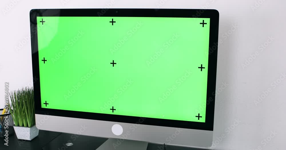 Green screen. Employee working at computer sitting at desk. View from back. Green screen. Employee working at computer sitting at desk. View from back.