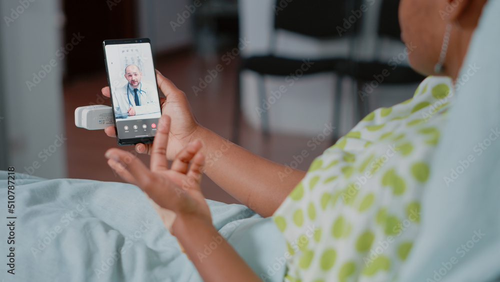 Close up of patient holding smartphone with video call, having remote consultation with doctor about healthcare and recovery. Woman using online conference, telemedicine and telehealth Close up of patient holding smartphone with video call, having remote consultation with doctor about healthcare and recovery. Woman using online conference, telemedicine and telehealth