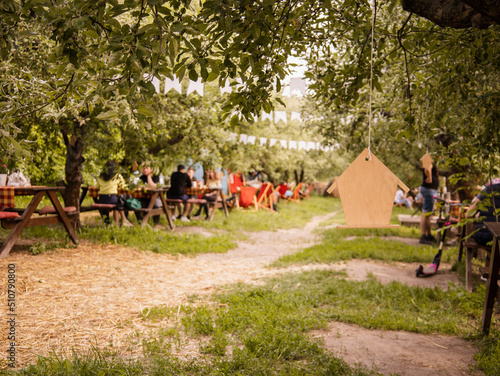 Summer picnic background. Picnic garden. Countryside concept. People chilling in summer picnic and park. Picnic table and bench. 