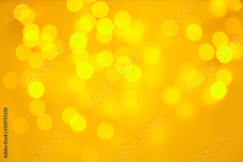 Glowing bokeh lights on a yellow background. Backdrop for postcard business card design