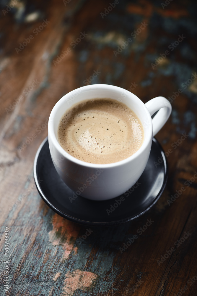 Cup of coffee on wooden background. Close up. Cup of coffee on wooden background. Close up.
