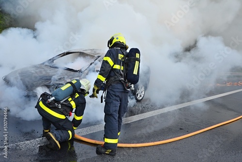 Firefighters extinguish the fire of a passenger car 