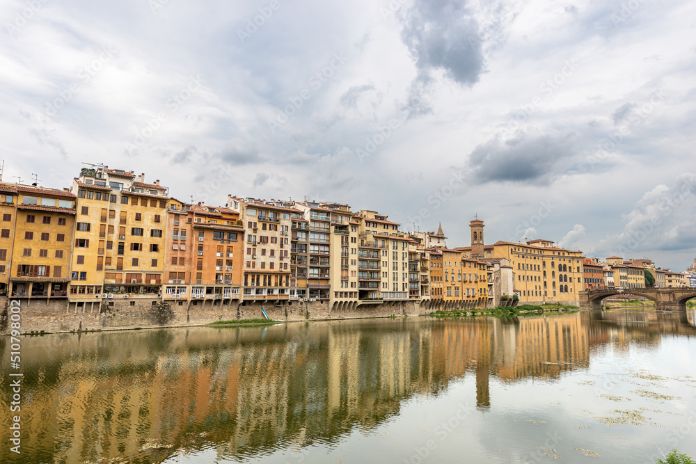 The Arno river with residential buildings and the Santa Trinita Bridge (Ponte Santa Trinita, XVI century) in Florence downtown, UNESCO world heritage site. Tuscany, Italy, Europe.