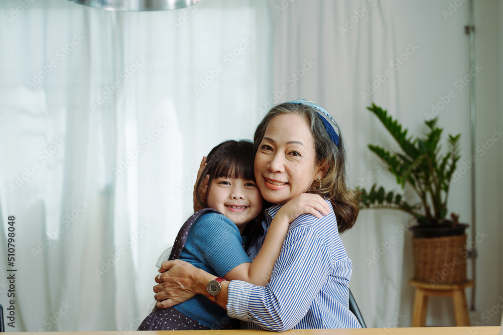 Asian portrait, grandma and granddaughter doing leisure activities and hugging to show their love and care for each other Asian portrait, grandma and granddaughter doing leisure activities and hugging to show their love and care for each other