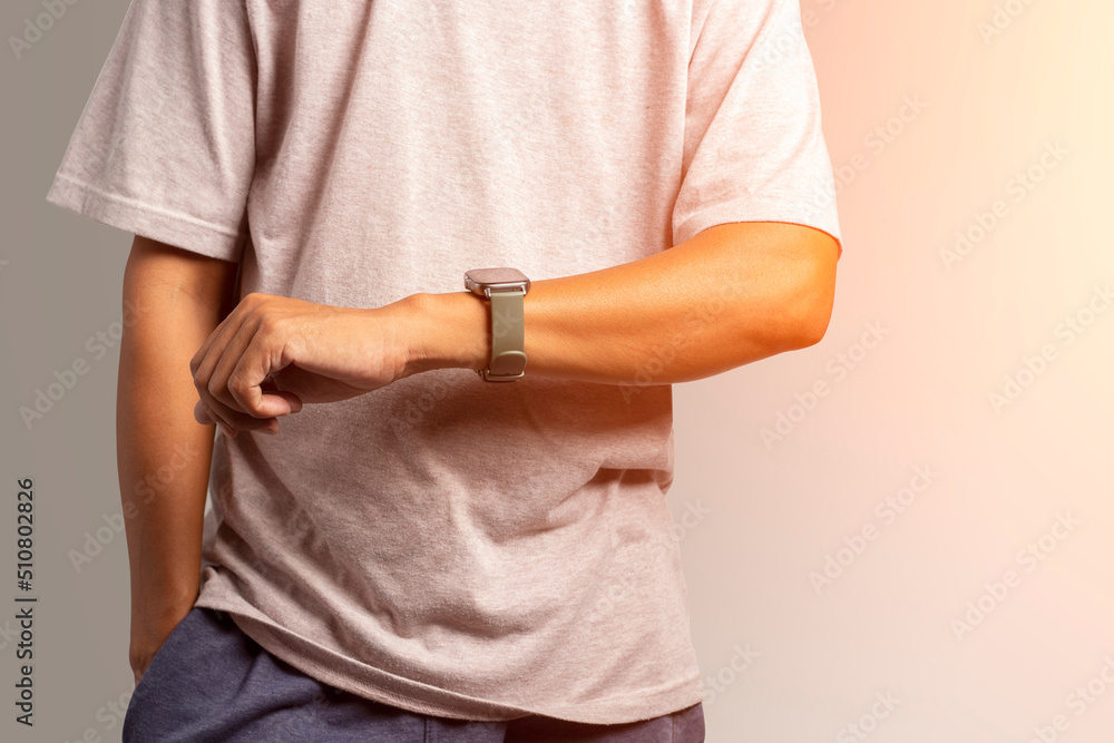Man looking at smartwatch or sport watch, checking distance and heart rate.