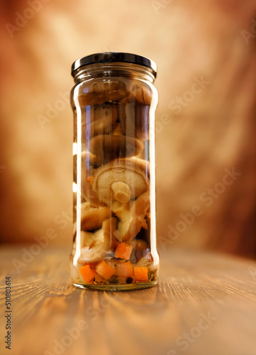 A jar of beautiful pickled mushrooms on a wooden table photo