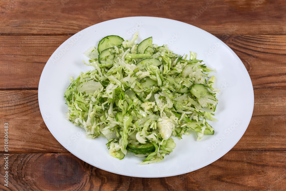 Green spring vegetable salad on dish on a rustic table Green spring vegetable salad on dish on a rustic table