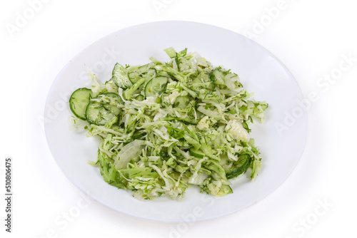 Green spring vegetable salad on dish on a white background
