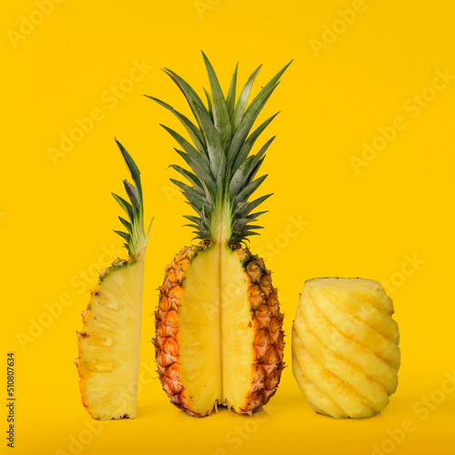 Fresh slice pineapple pieces on yellow . Closeup summer food and drink