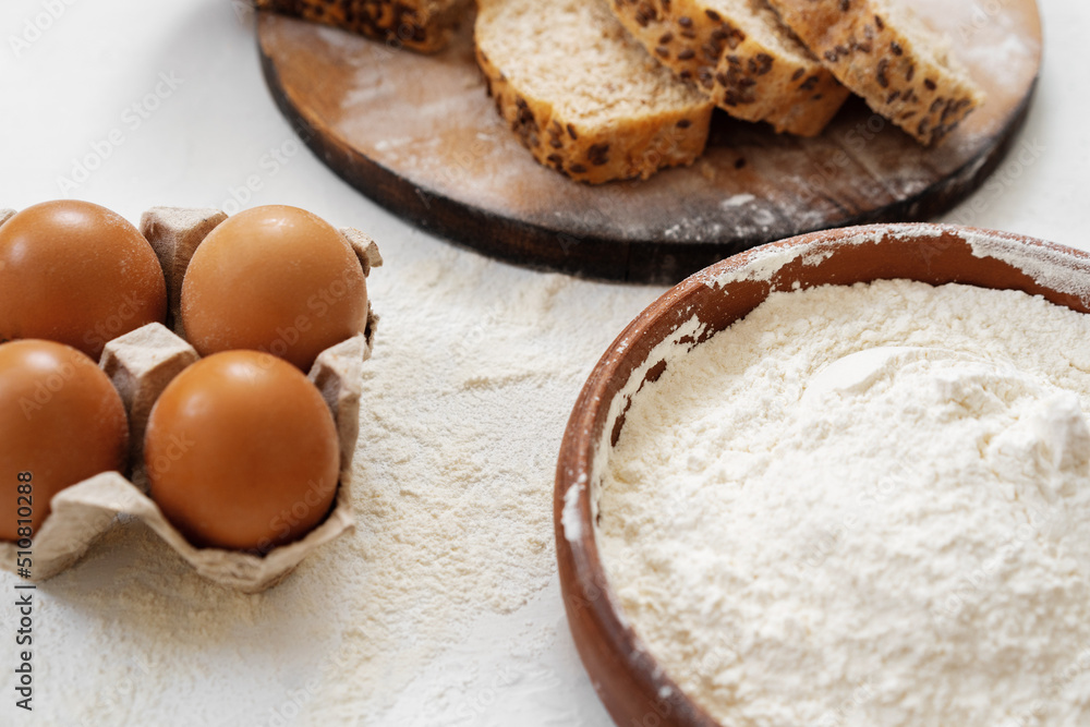 Preparation for baking. Eggs and flour on white background Preparation for baking. Eggs and flour on white background