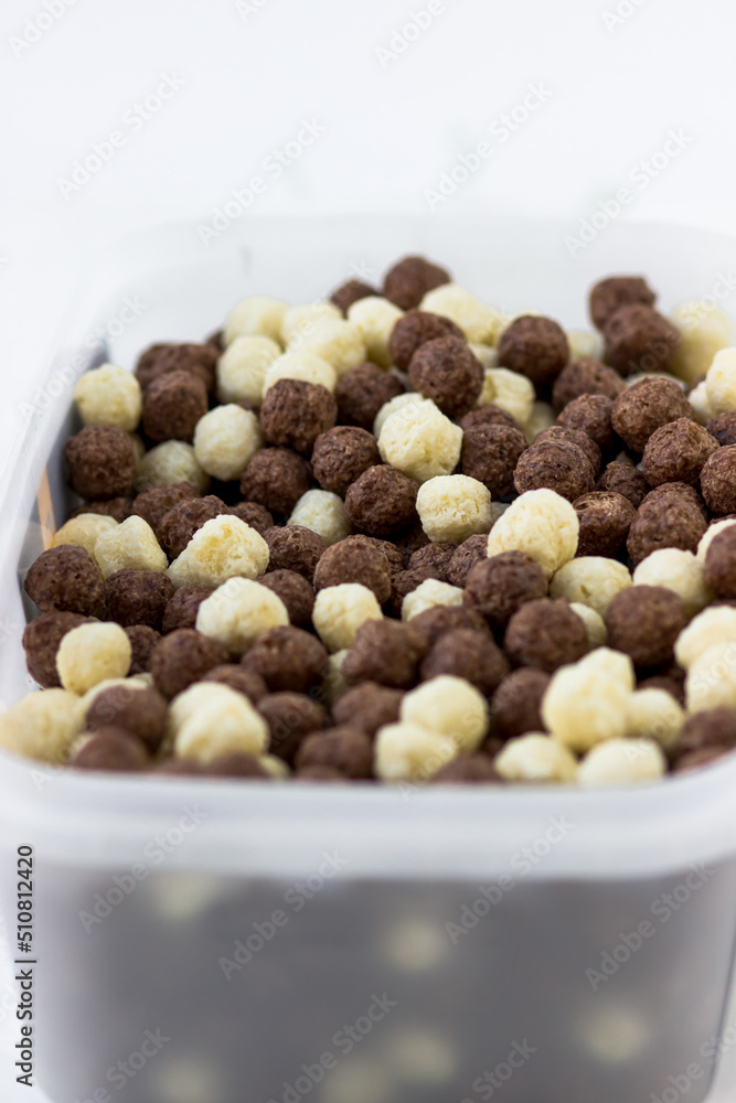 Chocolate and vanilla balls. Quick breakfast of corn snacks close-up Chocolate and vanilla balls. Quick breakfast of corn snacks close-up