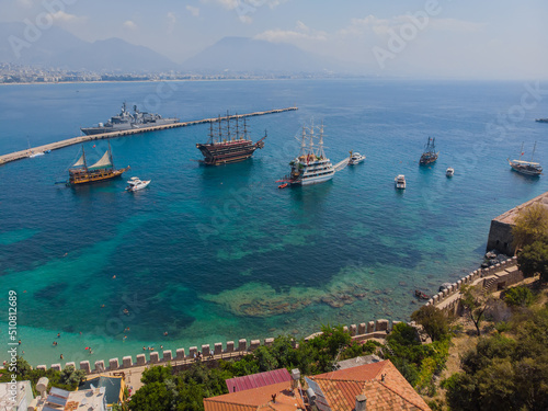 View from a height to the port of Alanya. Sea harbor. Mediterranean Sea. Lighthouses in the harbor at the exit from the water area of the port of Alanya. Turkey. Aerial photography.