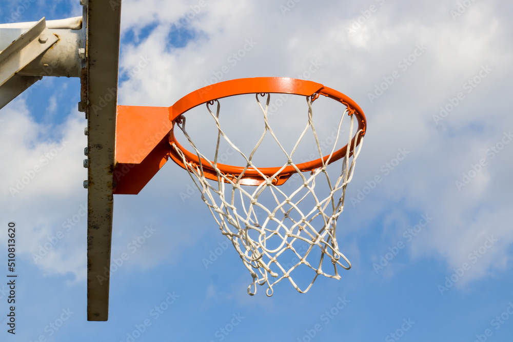 Orange color basketball hoop in blue sky with copy space