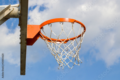 Orange color basketball hoop in blue sky with copy space © Gulsen