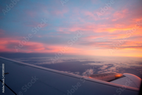 View from an airplane of a sunrise from the sky © Cristian Blázquez