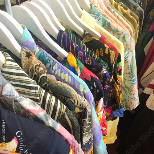 clothes on hangars in clothes shop